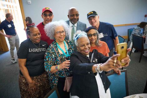 A group of alumni are taking a selfie. Ernest Jeffries, vice president for inclusion is in the photo.