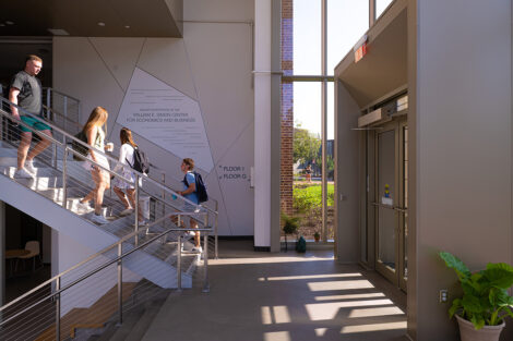 Students walk down a staircase in Simon Center.