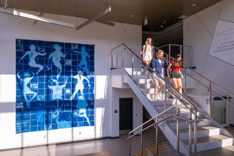 Students walk down a staircase in Simon Center.