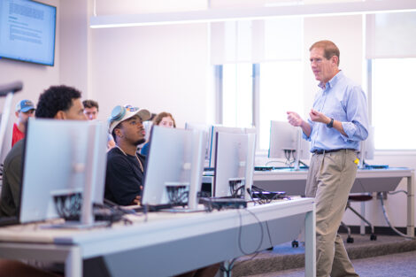 A professor teaches in a computer lab.