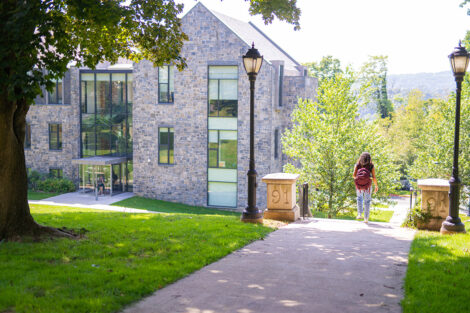 A student walks toward an academic building