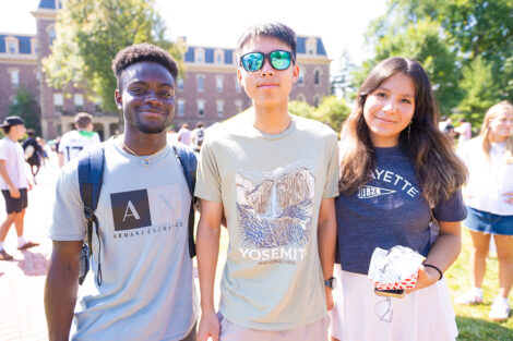 Students smile outside of Pardee Hall.