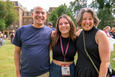 A student smiles with their family