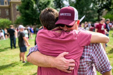 A father hugs their son