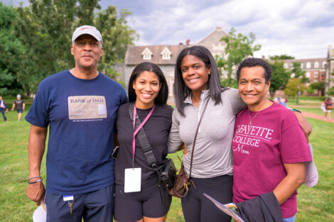 A student smiles with their family