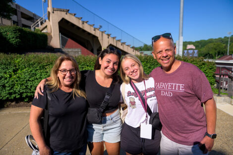 A student smiles with their family