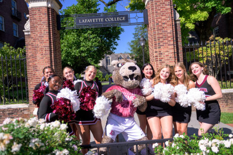 The Leopard smiles with cheerleaders and dance team members