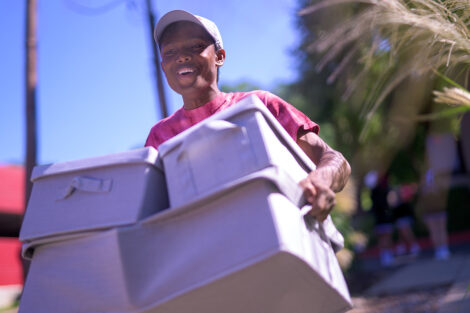 A student carries boxes