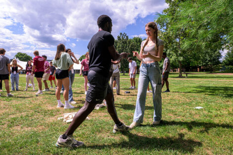 Students play a game in a circle.