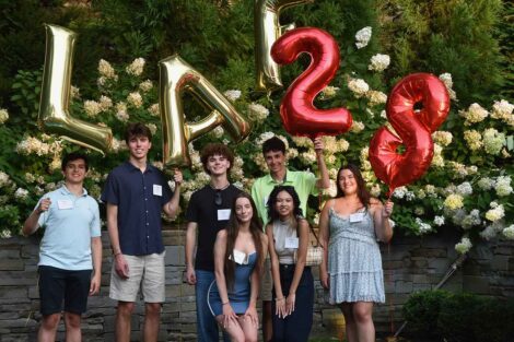 Incoming members of the Class of 2028 from Northern New Jersey are smiling at the camera. They are standing in front of balloons.