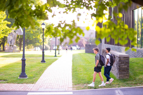 Two students walk next to Skillman Library