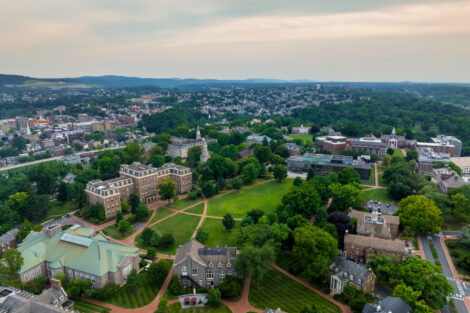 An aerial view of Lafayette college's quad. The top 25% of the frame is and early evening sky. The city of Easton Pa and it's West Ward can be seen in the background.