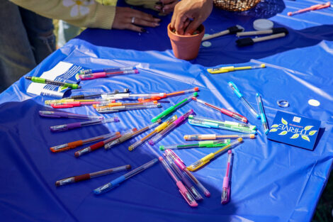 Bright colored pens on a tablecloth