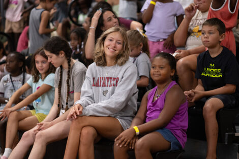 A Lafayette student smiles with a younger child.