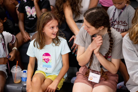 A Lafayette student smiles with a younger child.