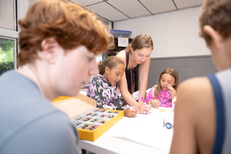 A Lafayette student does crafts with a younger child.