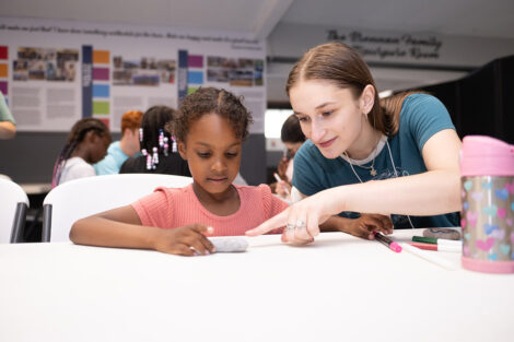 A Lafayette student does crafts with a younger child.