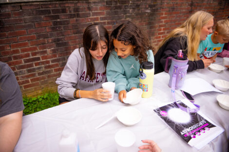 A Lafayette student does crafts with an elementary student