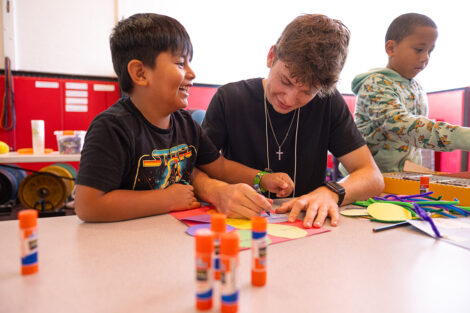 A Lafayette student does crafts with an elementary student