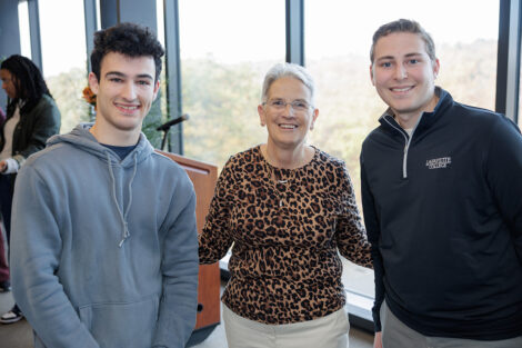 Rosie is pictured with two students.