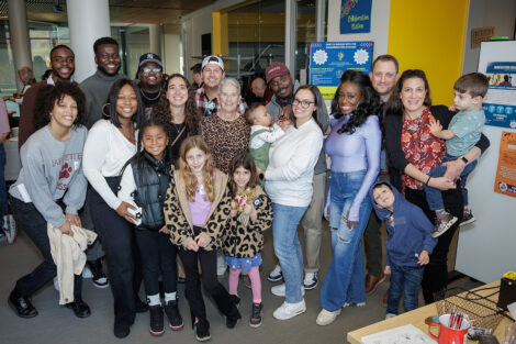 A large group of people are posing for the camera