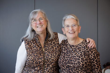 Wendy Hill and Rosie Bukics are standing arm in arm.