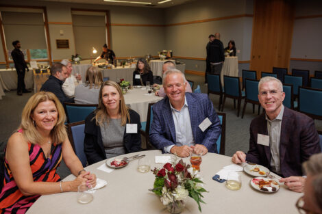 Four family members are seated at a table.