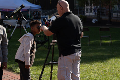 A young visitor gets to look through a solar telescope at Space FEst.