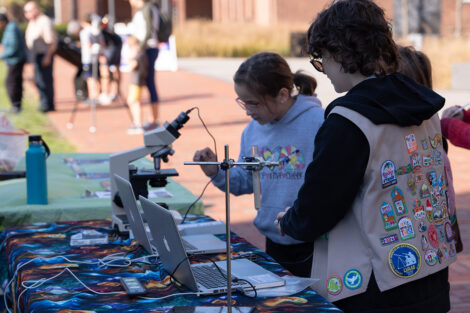 A young Girl Scout gets the chance to look through a microscope during LV Space Fest