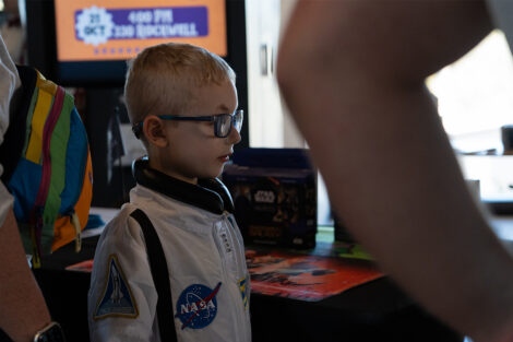 A young visitor in an astronaut costume explores the exhibits at Space Fest.