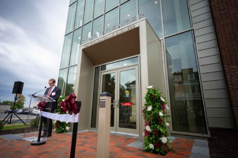 David Stifel, Charles A. Dana Professor of Economics Department Head is standing at a podium in front of the Simon Center.