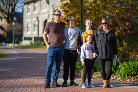 A family of five are standing on the Quad.