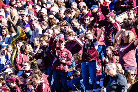 The crowd cheers during a football game.