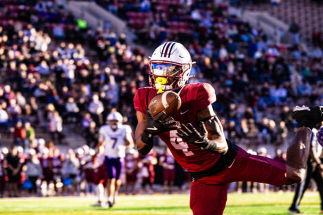 A football player catches a ball.