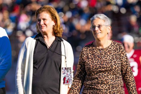 President Hurd and Rosie Bukics are standing next to each other at a football game.