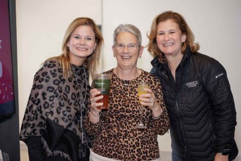 President Hurd is standing with Rosie Bukics and Audra Kahr. Audra and Rosie are wearing leopard print.