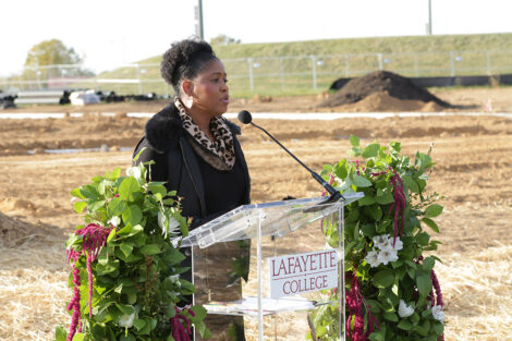 Sherryta Freeman is standing at a podium.