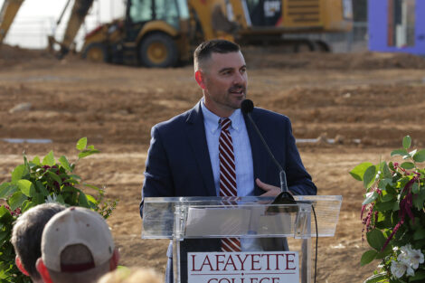 Coat Myers is standing at a podium.