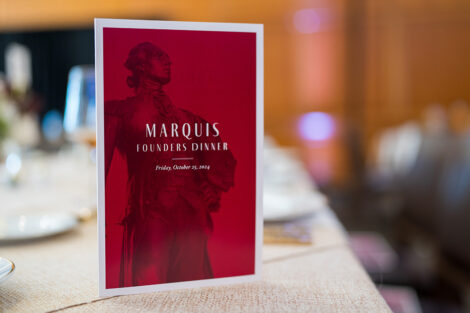 The program for the Marquis Society dinner is displayed on a table.