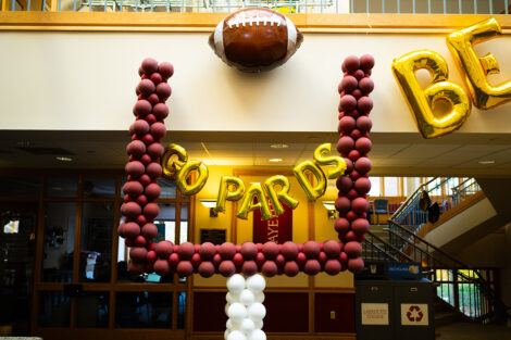 A balloon display of a field goal and a football that reads 