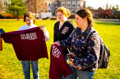 Students look at new maroon t-shirts.