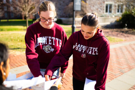 Students smile, wearing Lafayette sweatshirts