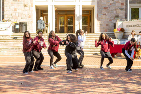 A dance group performs in front of Farinon College Center.