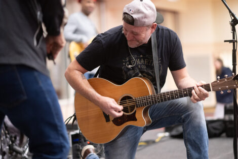 A musician plays guitar.