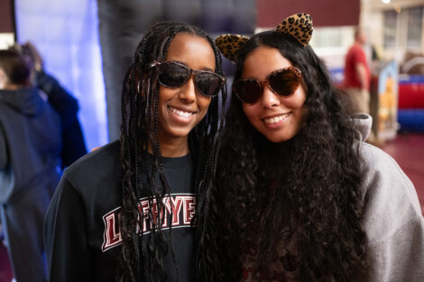 Students smile in sunglasses and Leopard cat ears.