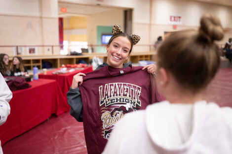 A student holds up a Lafayette tshirt.