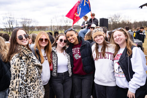 Students smile, wearing leopard, maroon, and white.