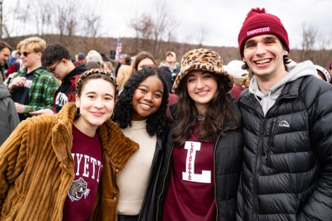 Students smile, wearing leopard, maroon, and white.