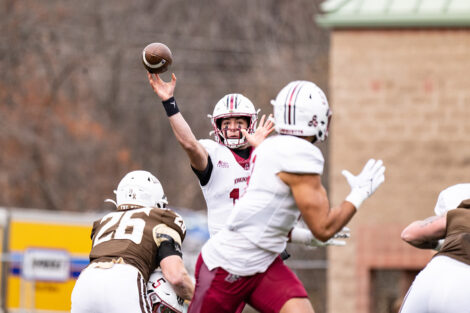 A football player throws the ball.