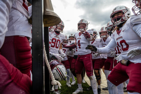 Lafayette football players near the victory bell.